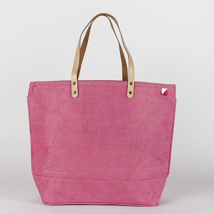 Big Jute Colored Tote Bags in pink with durable tan straps for stylish shopping and outings.
