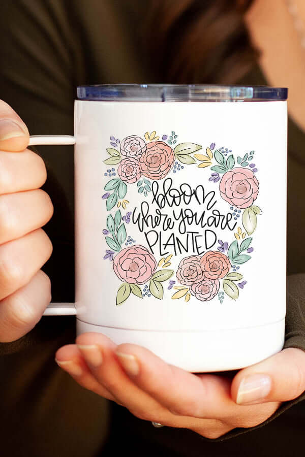 Bloom Coffee Travel Cup with floral design and inspirational text 'Bloom Where You Are Planted' for coffee lovers.