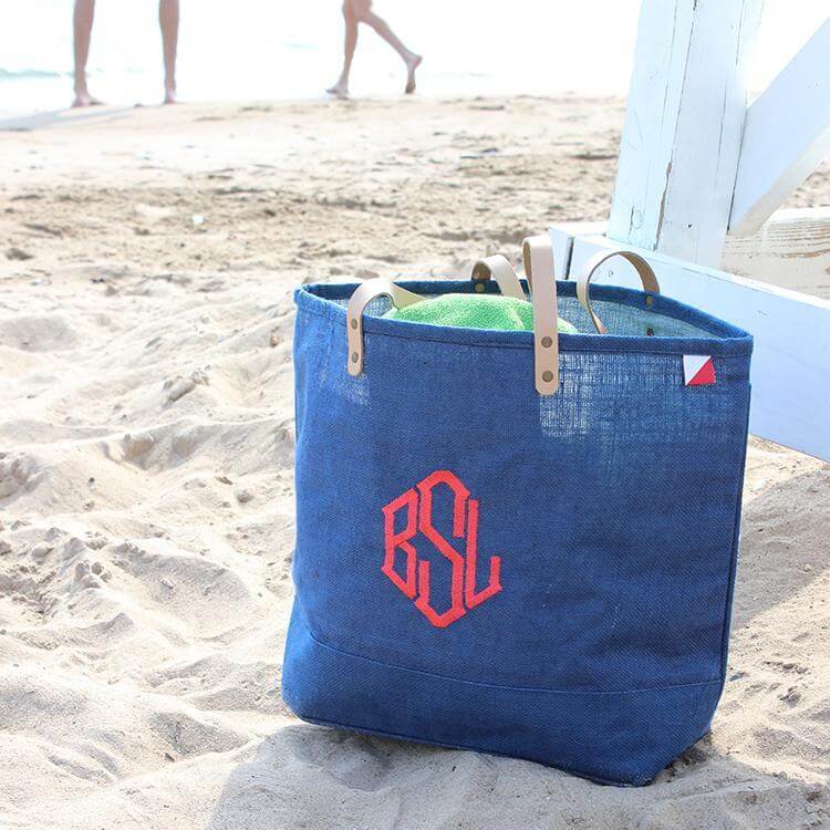 Big Jute Colored Tote Bags on the beach with a stylish design and durable straps, perfect for shopping and outings.