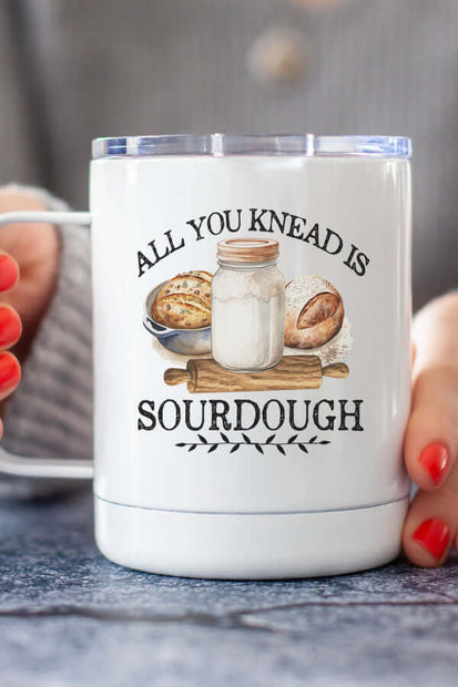 All You Knead Coffee Cup featuring a design with sourdough elements and a mason jar on a wood background.