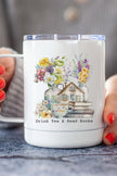 Drink Tea Travel Cup with floral design and text 'Drink Tea & Read Books' held by person.