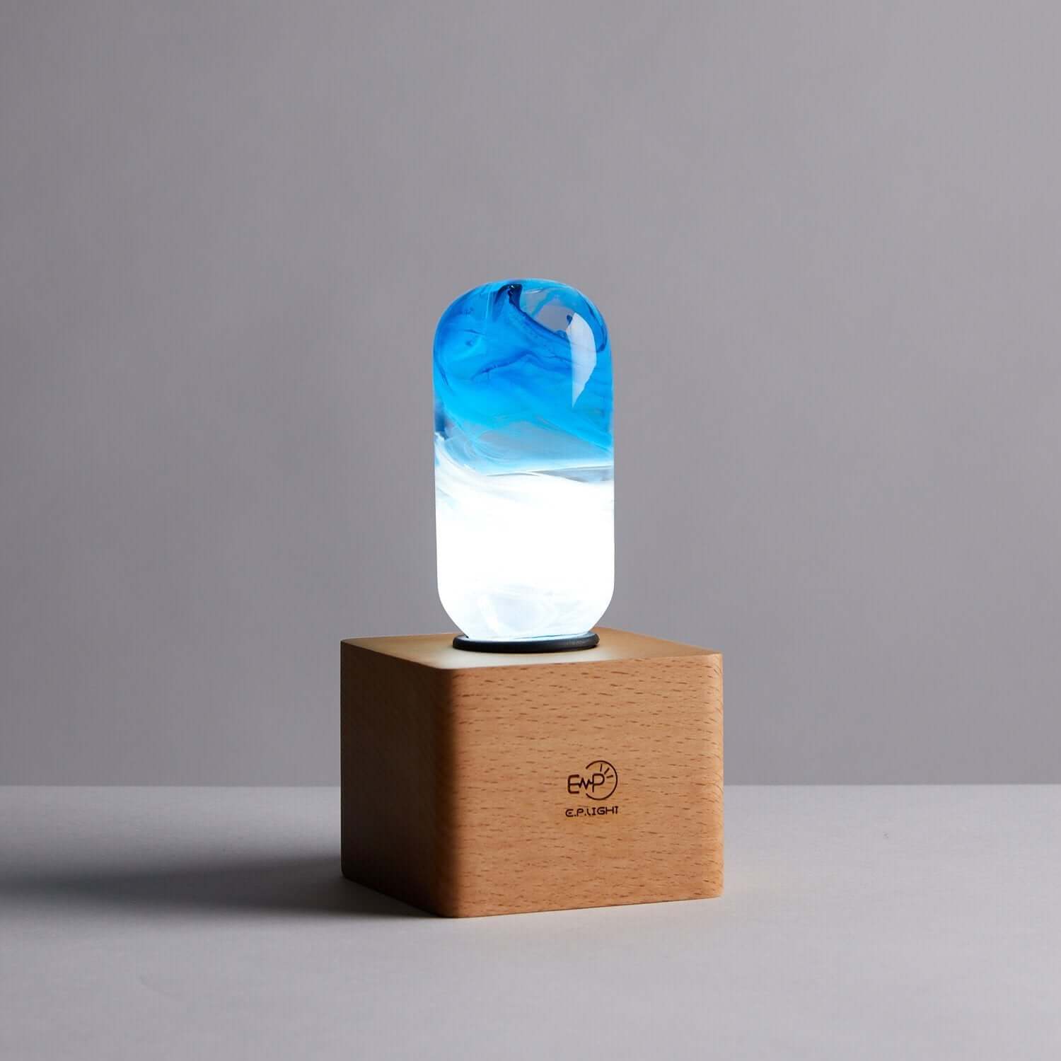 Elegant Blue Lamp providing warm ambient light on a wooden base, creating a cozy atmosphere in any room.