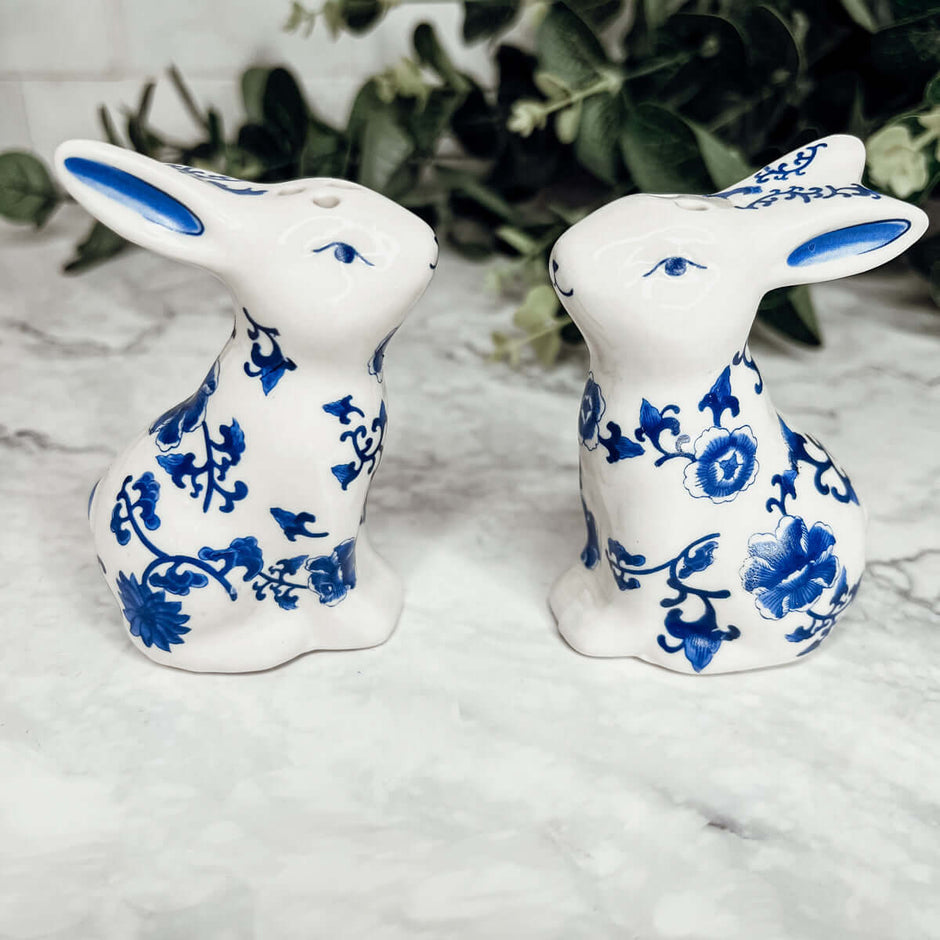 Blue Bunny Shakers, decorative ceramic salt and pepper shakers shaped like bunnies, featuring blue floral designs.