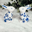 Blue Bunny Shakers, decorative ceramic salt and pepper shakers shaped like bunnies, featuring blue floral designs.