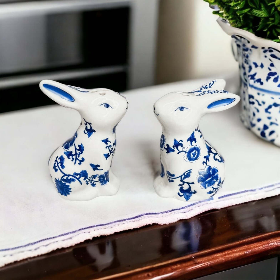Blue Bunny Shakers beautifully crafted in white and blue porcelain, featuring floral designs, perfect for home decor.