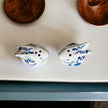 Blue Bunny Shakers in a decorative ceramic rabbit design on a tabletop.