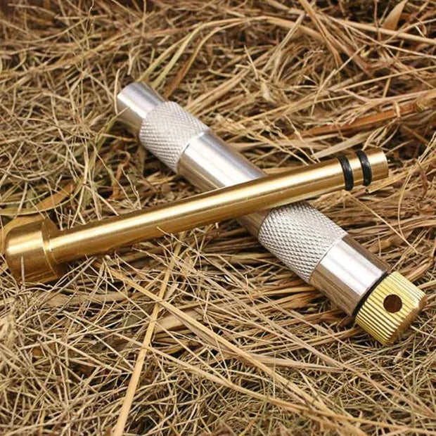 Portable Metal Fire Piston with Brass-Coloured Rod and Knurled Grip for Camping Survival