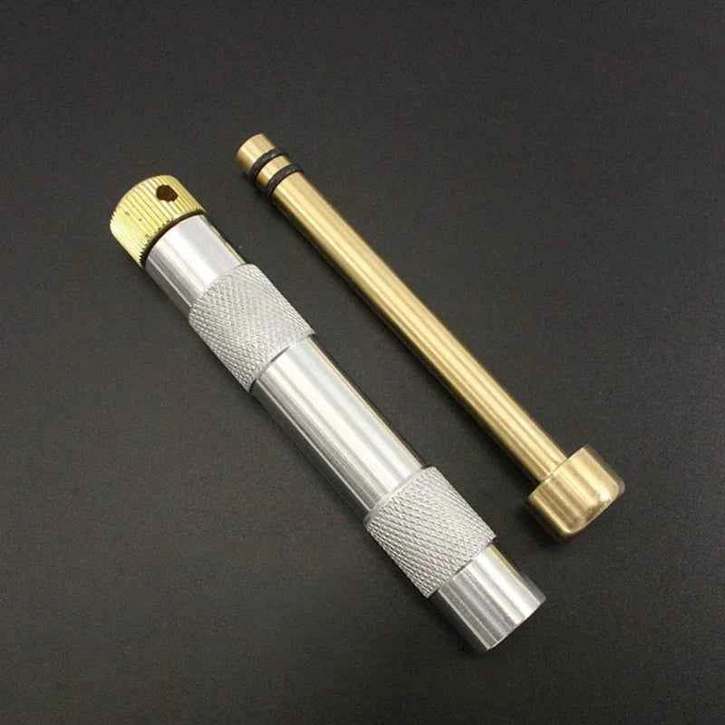 Portable Metal Fire Piston with Brass-Coloured Rod and Knurled Grip for Camping Survival