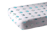 Cotton crib sheet with a playful robot pattern in blue and gray colors on a white background.