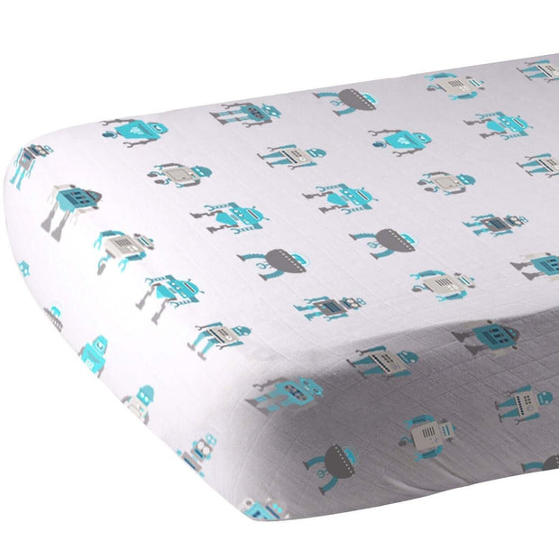 Cotton crib sheet with a playful robot pattern in blue and gray colors on a white background.