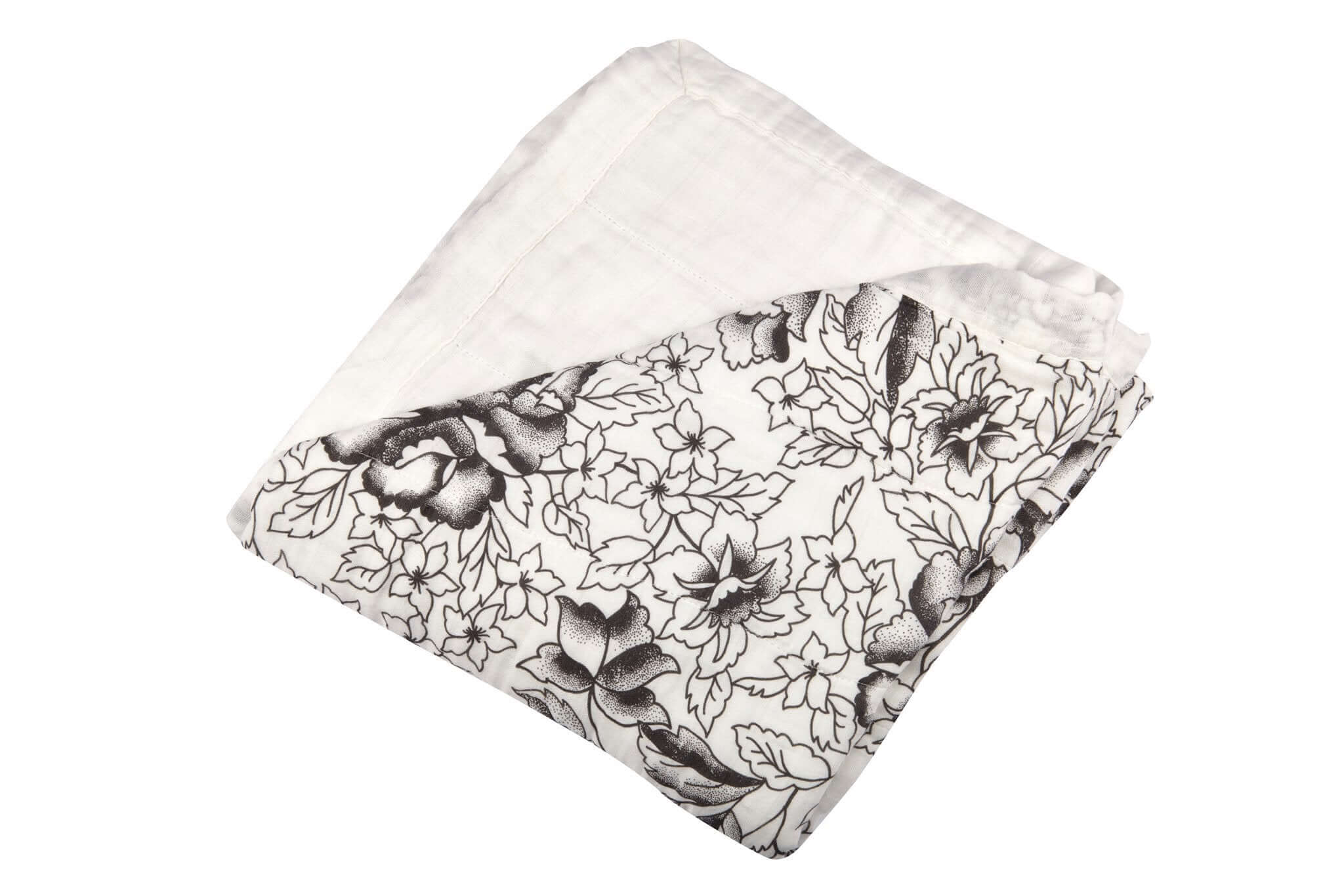 American Rose Newcastle Blanket with floral designs in black and white, folded neatly for cozy warmth.