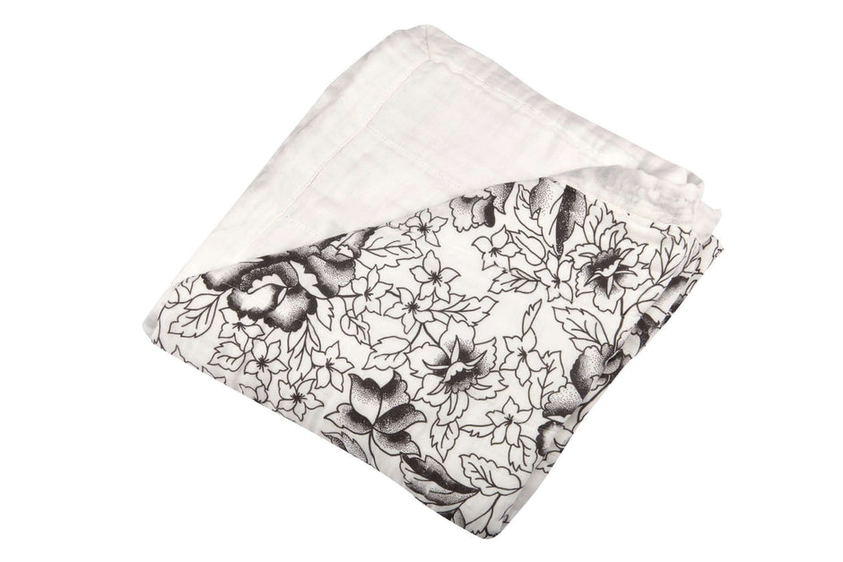 American Rose Newcastle Blanket with floral designs in black and white, folded neatly for cozy warmth.