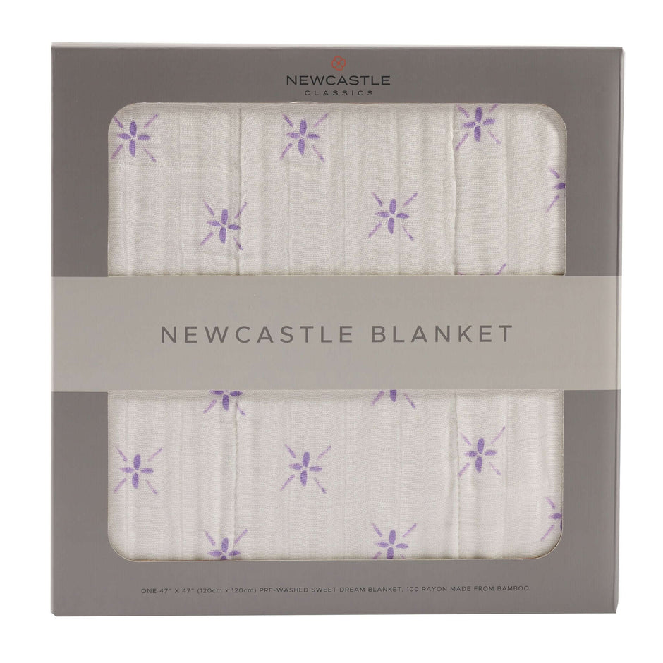 Newcastle Blanket packaging with purple flower design, perfect for cozying up.