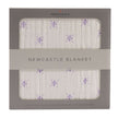 Newcastle Blanket packaging with purple flower design, perfect for cozying up.