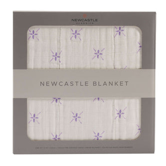 Newcastle Blanket packaging with purple flower design, perfect for cozying up.
