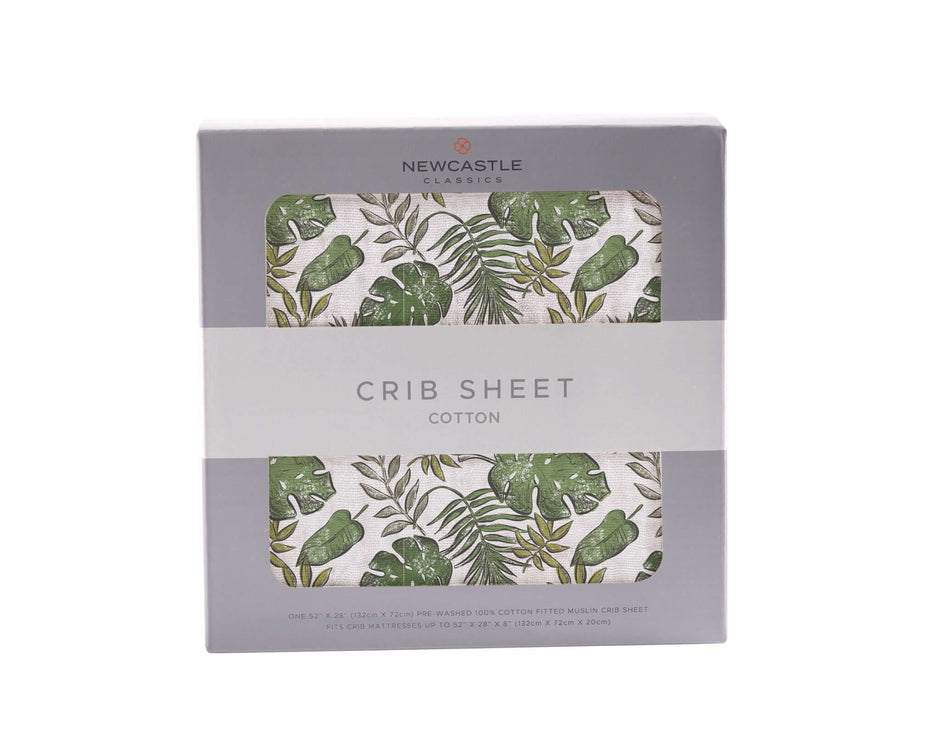 Tropical crib sheet with green leaf pattern in a box, made from soft cotton for comfortable baby bedding.