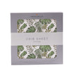 Tropical crib sheet with green leaf pattern in a box, made from soft cotton for comfortable baby bedding.