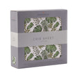 Tropical forest crib sheet in a cotton fabric, featuring green leaves and plants, perfect for nursery decor.