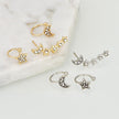 Conjunto de pendientes y brazaletes con forma de luna y estrella
