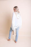 Kimonos à pompons et médaillons au crochet.