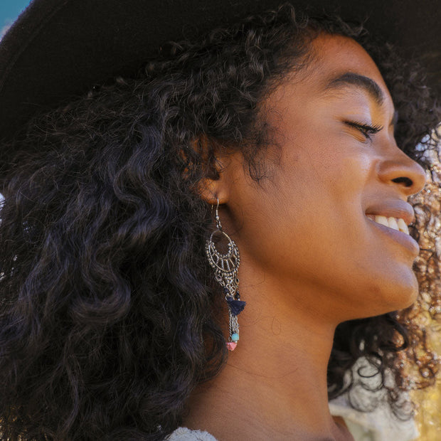Boucles d'oreilles pendantes en quartz rose et pompons.