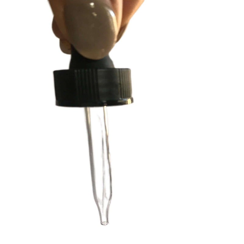 Close-up of a black bulb glass pipette dropper top for orange glass dropper bottles.