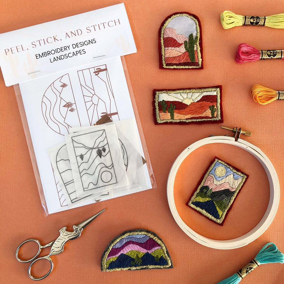 Landscape Embroidery Kit with various desert and Pacific Northwest designs, embroidery thread, and scissors.