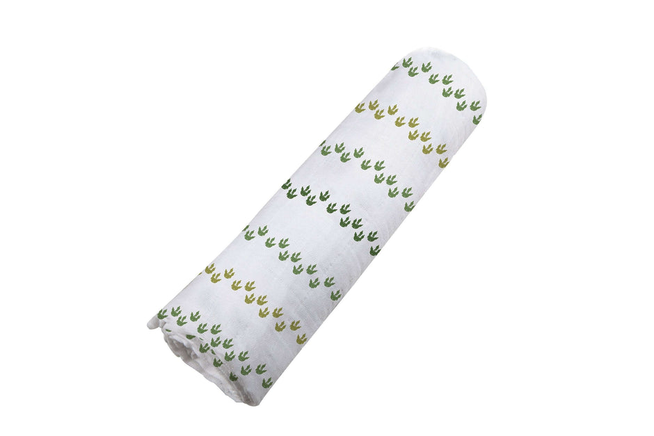 Dino Feet Cotton Muslin Swaddle featuring dinosaur footprints on soft cotton fabric.