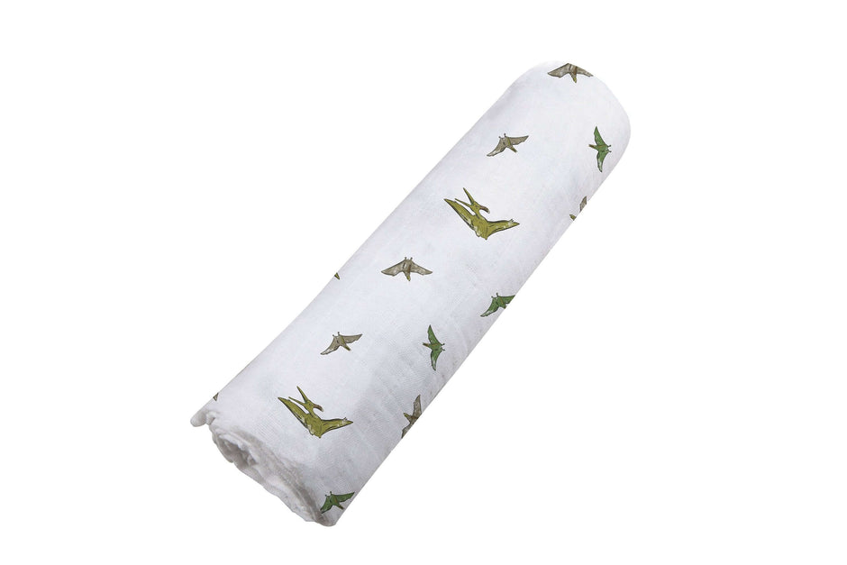Pteranodon Cotton Swaddle with playful dinosaur prints, soft muslin fabric for baby's comfort.