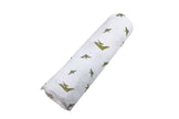 Pteranodon Cotton Swaddle with playful dinosaur prints, soft muslin fabric for baby's comfort.