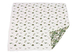 Dino Days Newcastle Blanket featuring playful dinosaur prints and a leafy pattern on the reverse side.