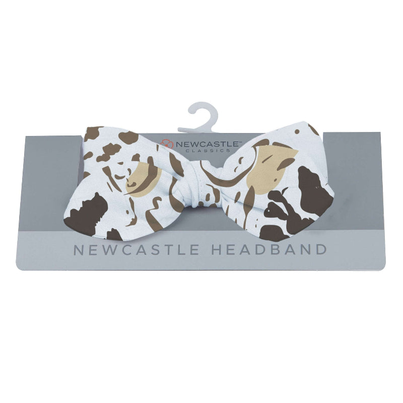 Animal Print Headband featuring a bow design in cow pattern, ideal for stylish fashion accessories.
