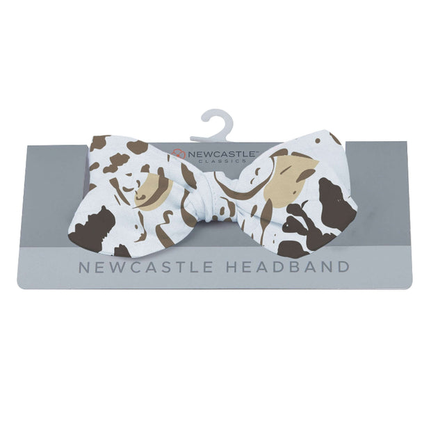 Animal Print Headband featuring a bow design in cow pattern, ideal for stylish fashion accessories.