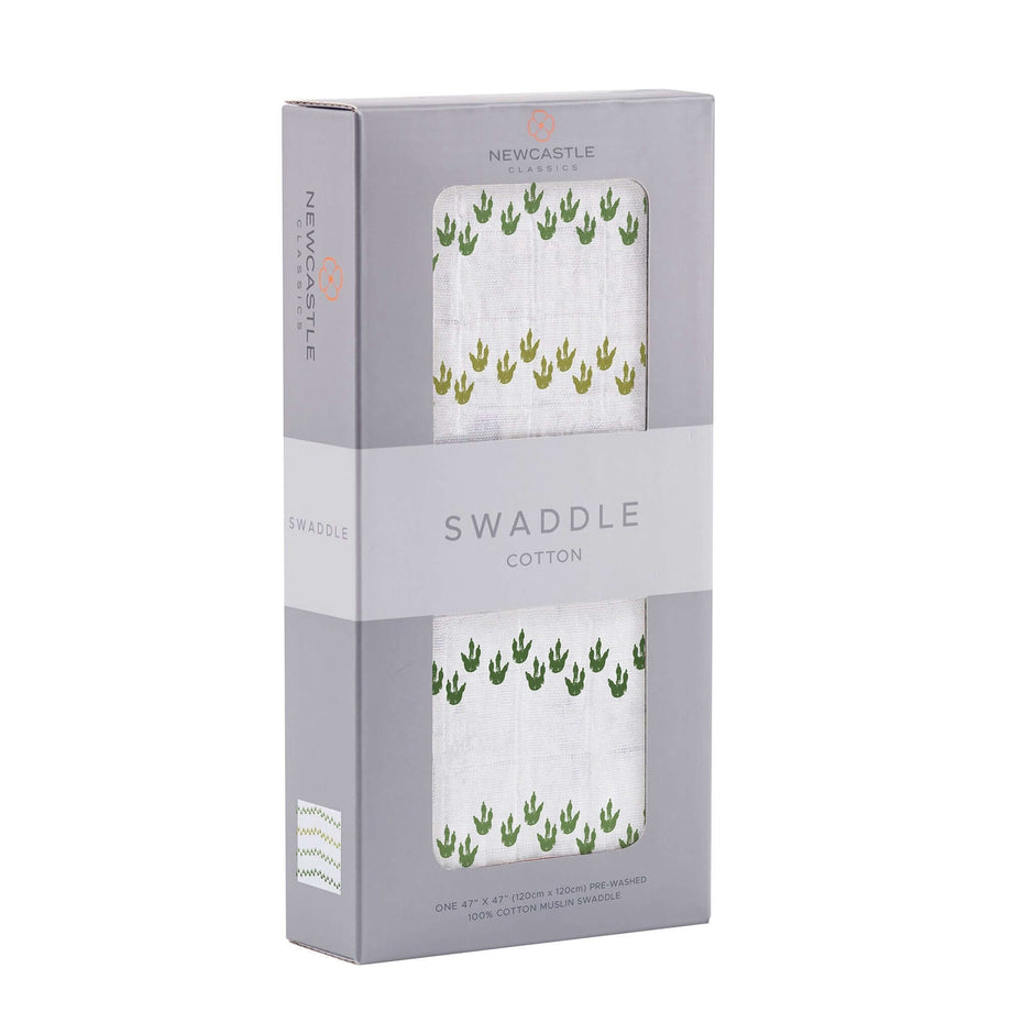 Dino Feet Cotton Muslin Swaddle, featuring green dino footprints, made of soft cotton, perfect for wrapping babies.