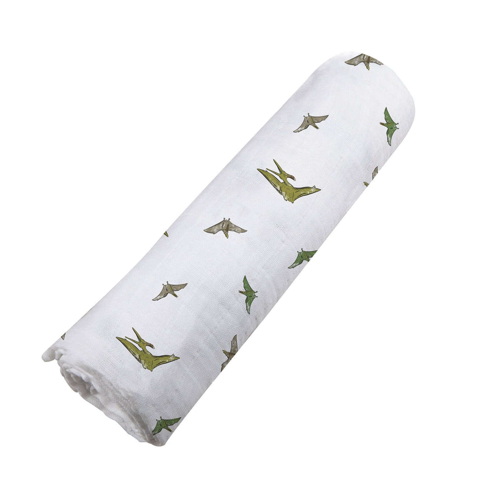 Pteranodon cotton swaddle featuring playful dinosaur prints for babies, perfect for cozy naps.