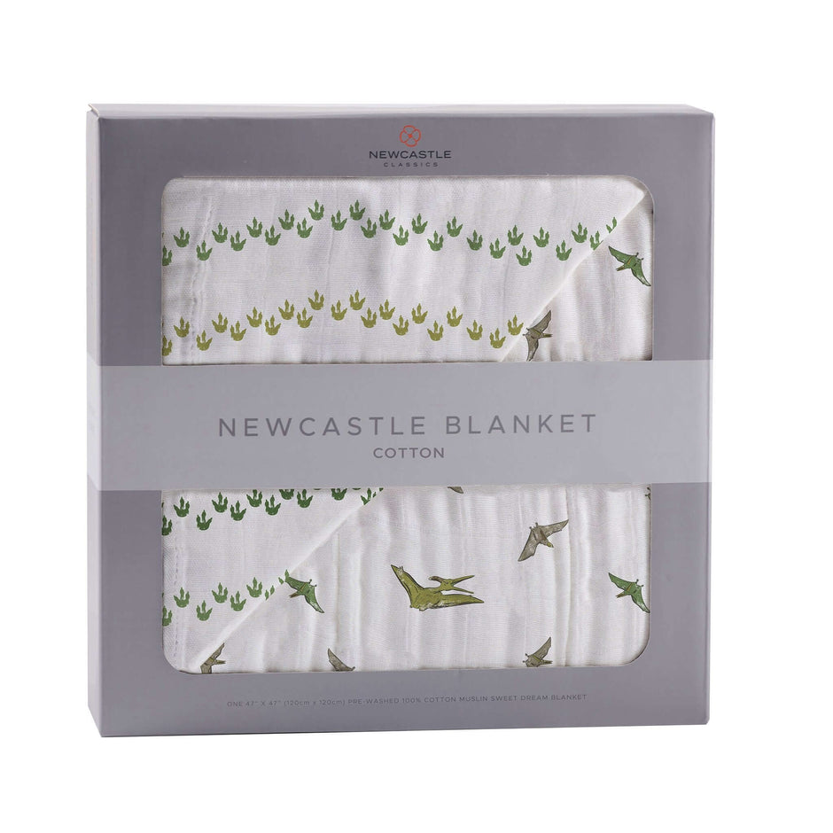 Dino Feet Muslin Blanket in a stylish box featuring dinosaur footprints and green designs.
