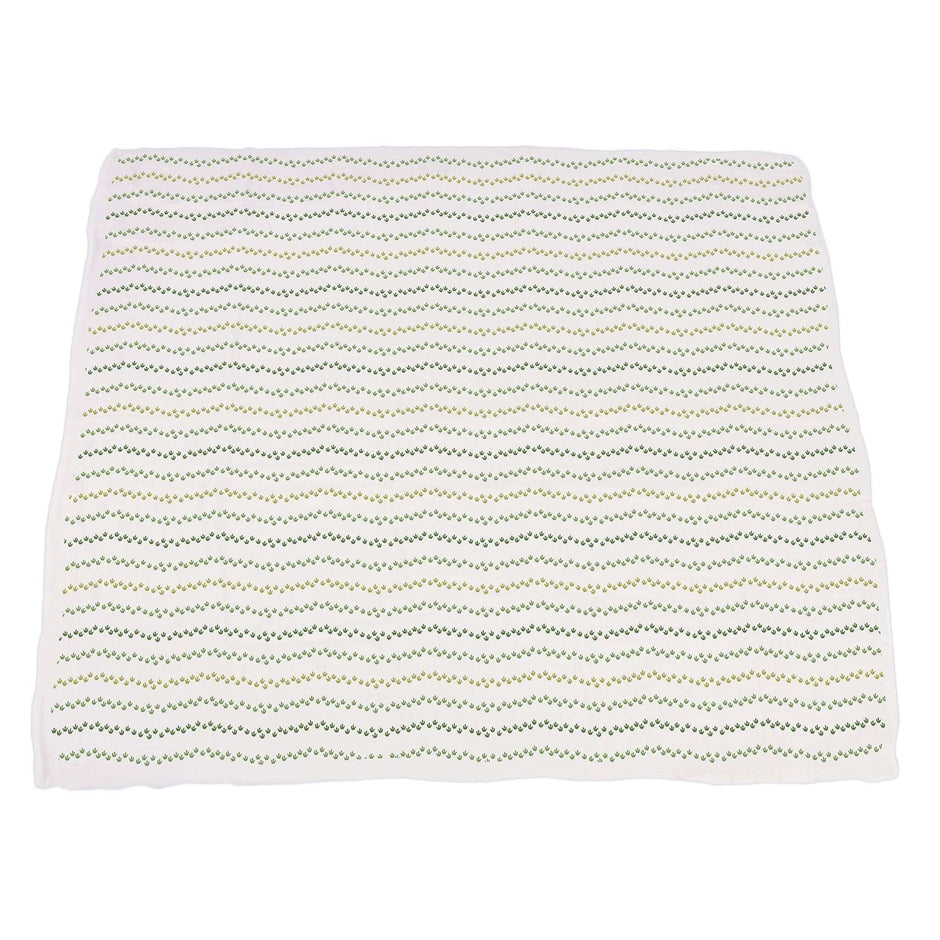 Dino Feet Muslin Blanket featuring a soft, patterned design with a green and white chevron style for cozy comfort.