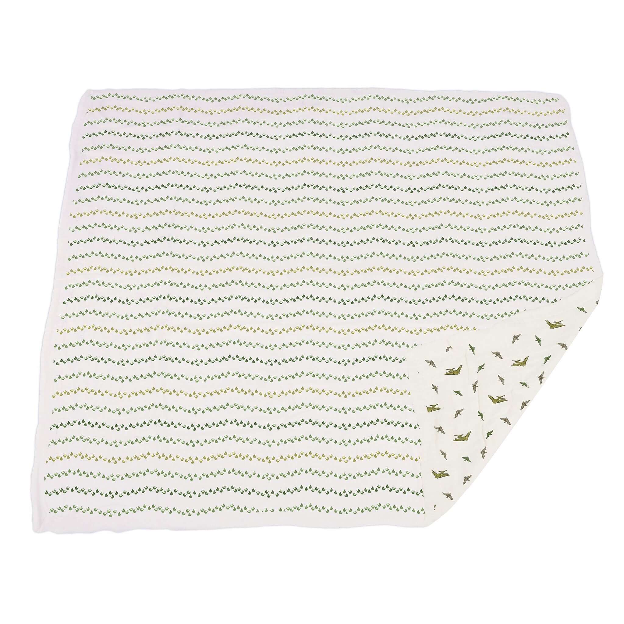 Dino Feet muslin blanket featuring a playful dinosaur print and a zigzag pattern on a soft fabric.