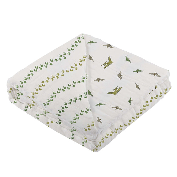 Dino Feet Muslin Blanket featuring playful dinosaur footprints and illustrations, perfect for cozying up.