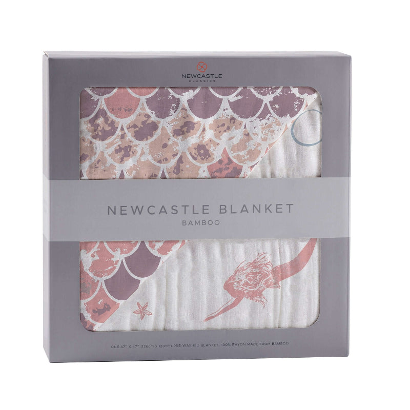 Mermaid Scales Blanket in packaging showcasing whimsical mermaid scales design and bamboo material for cozy comfort.
